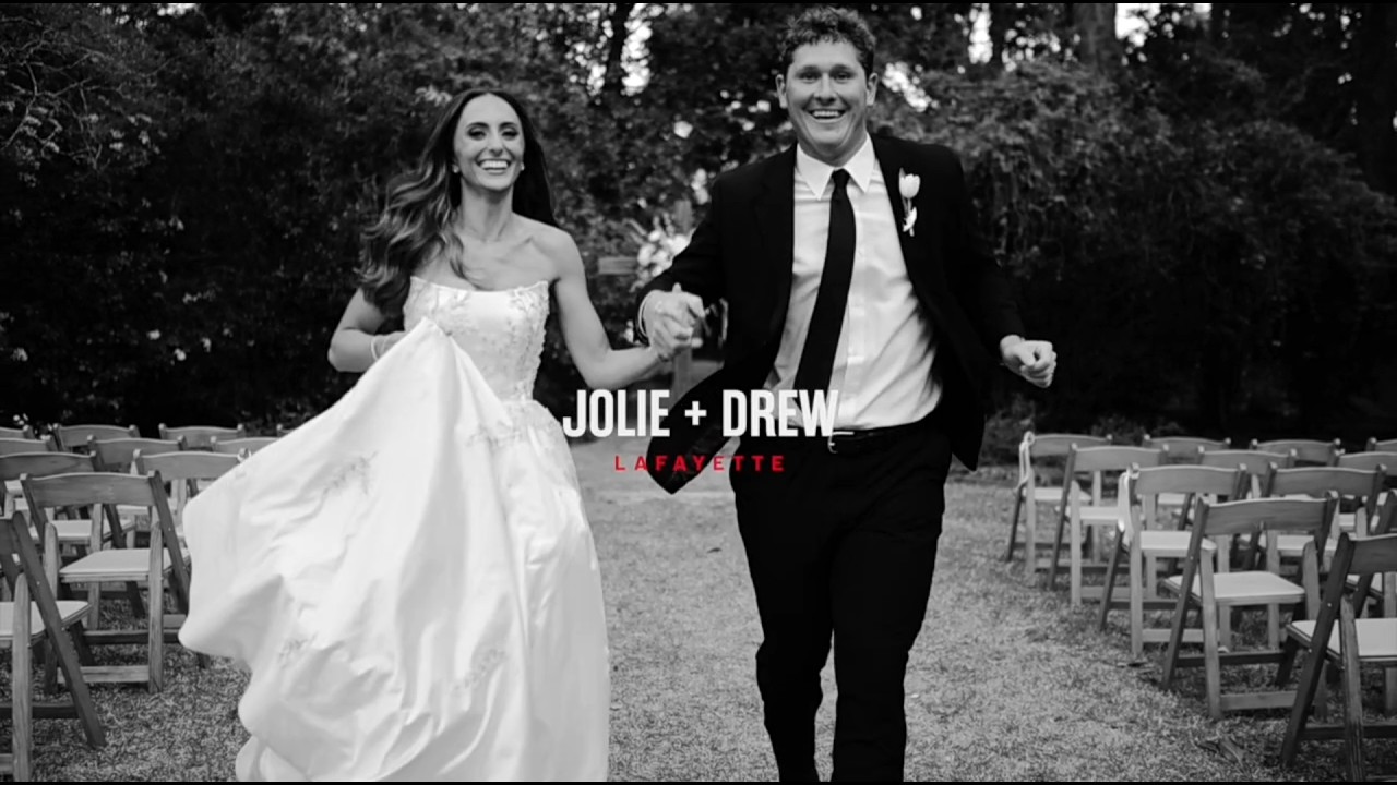 Bride and Groom run hand in hand down the aisle.